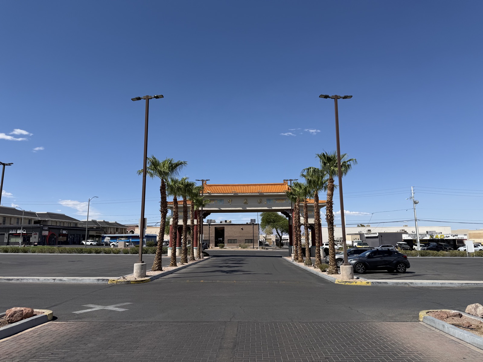 The ceremonial gate at the entrance to Chinatown Plaza on Spring Mountain Road in Las Vegas, flanked by palm trees