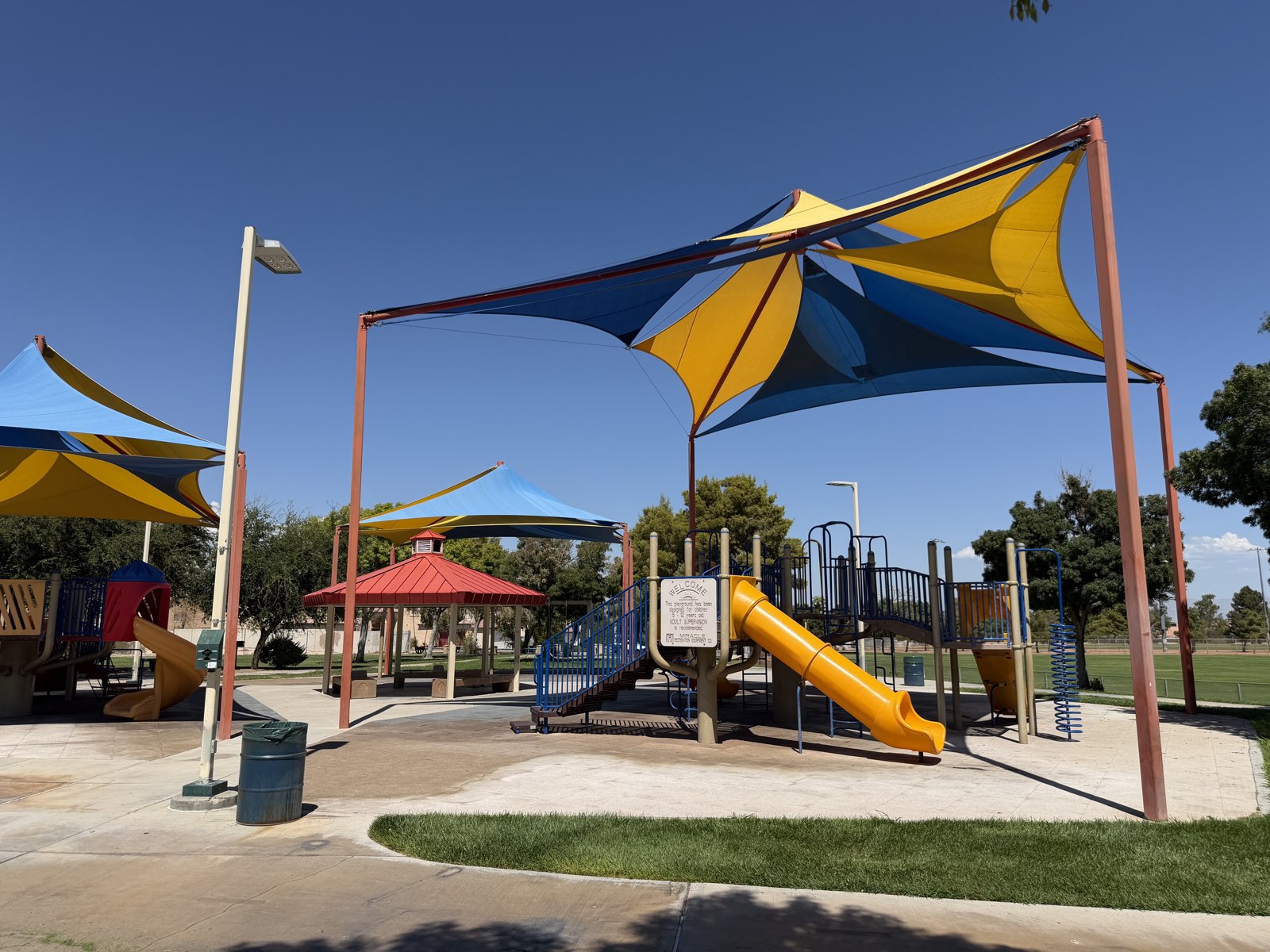 Blue and yellow shade sails over the playground equipment at Desert Bloom Park in Southeast Las Vegas