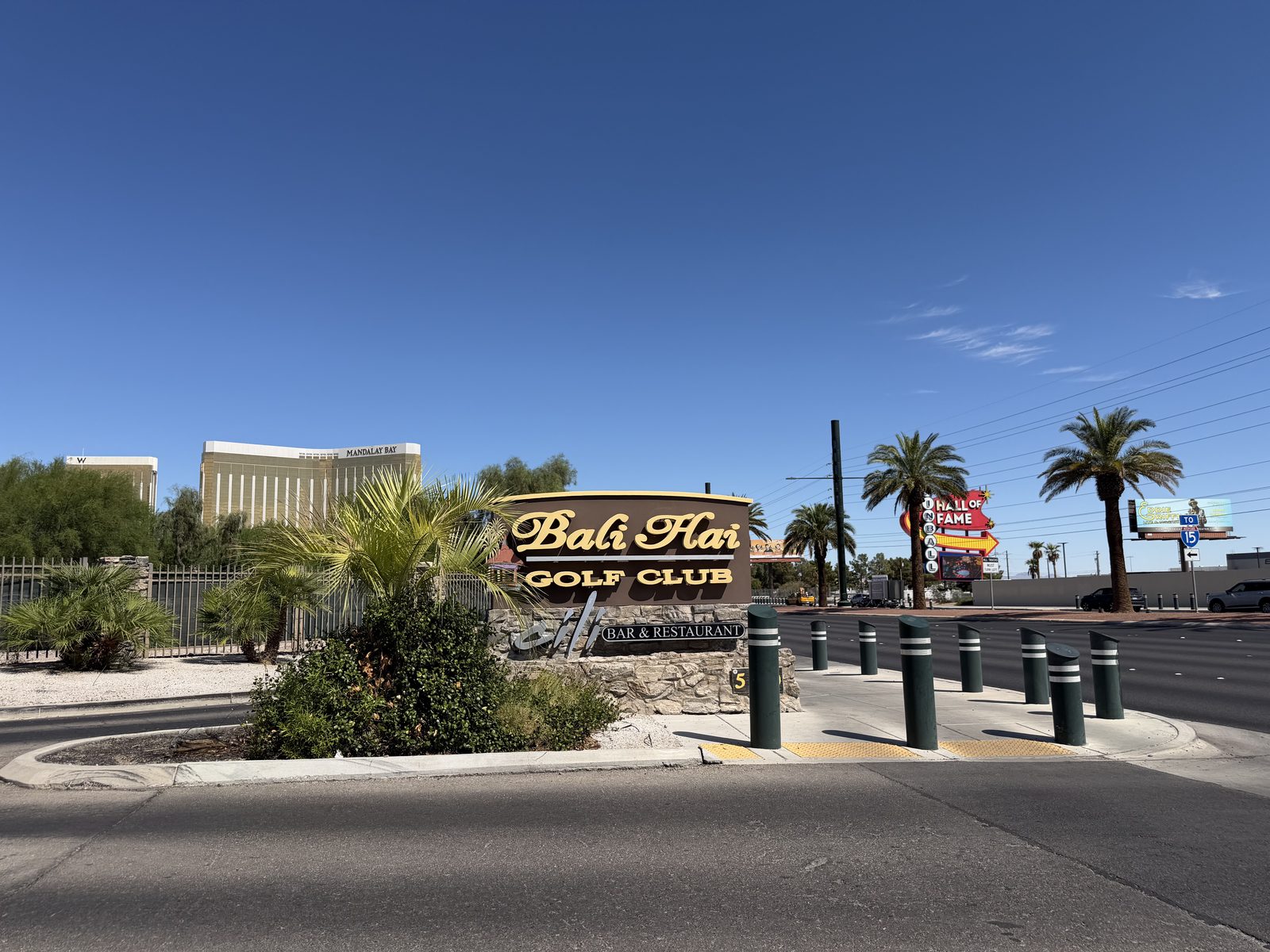 The Bali Hai Golf Club monument sign on Las Vegas Boulevard with Mandalay Bay rising behind it