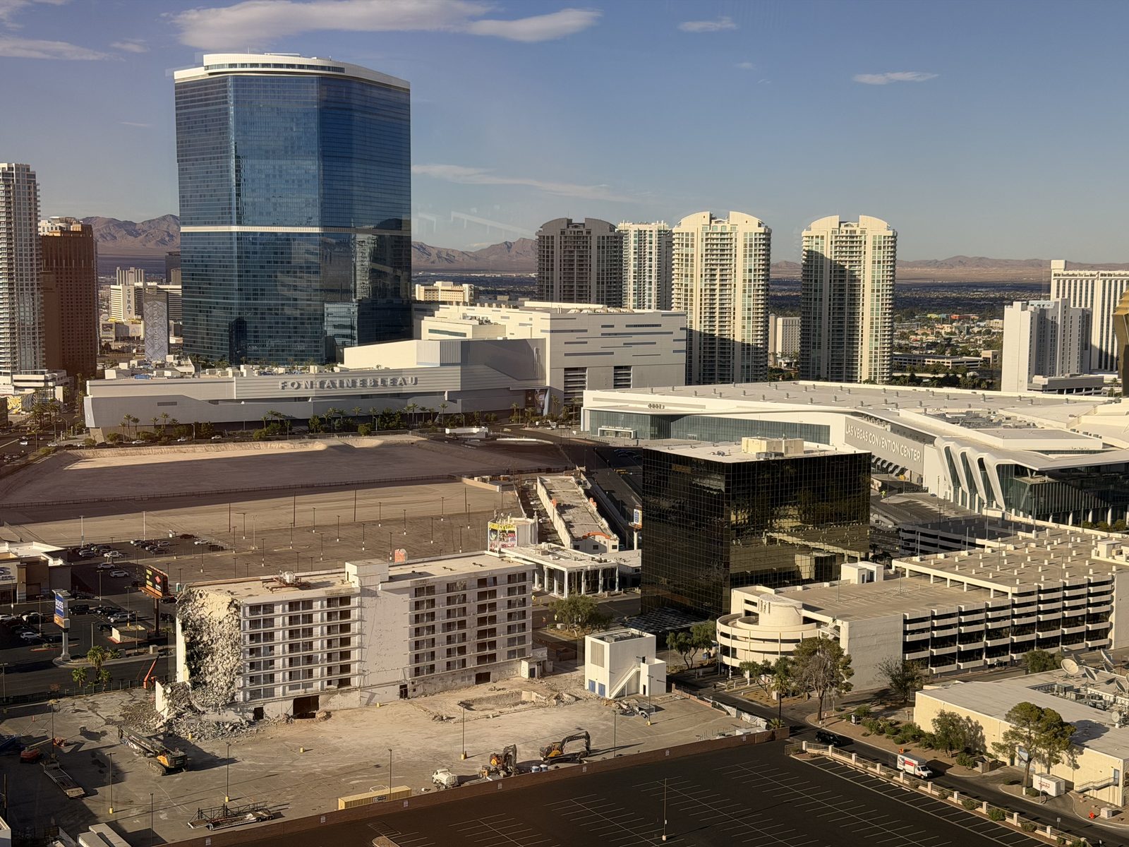 Elevated view over the Las Vegas Convention Center campus with the blue Fontainebleau tower and a row of residential high-rise towers behind it