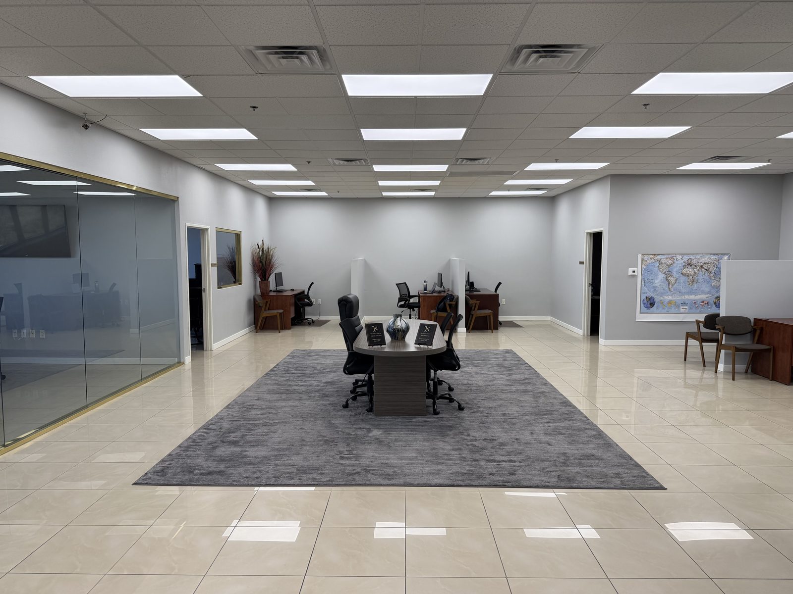 A wider view of the Vegas VIP Me conference room showing the full table, seating and the window wall beyond