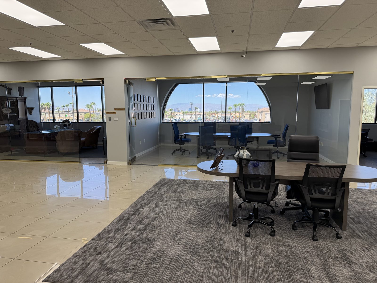The conference room at the Vegas VIP Me office on South Maryland Parkway, with a full wall of windows looking out over Southeast Las Vegas