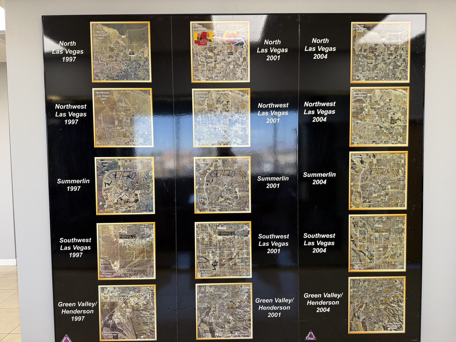 Framed aerial photographs in the Vegas VIP Me office showing North Las Vegas, Northwest Las Vegas, Summerlin, Southwest Las Vegas and Green Valley in 1997, 2001 and 2004