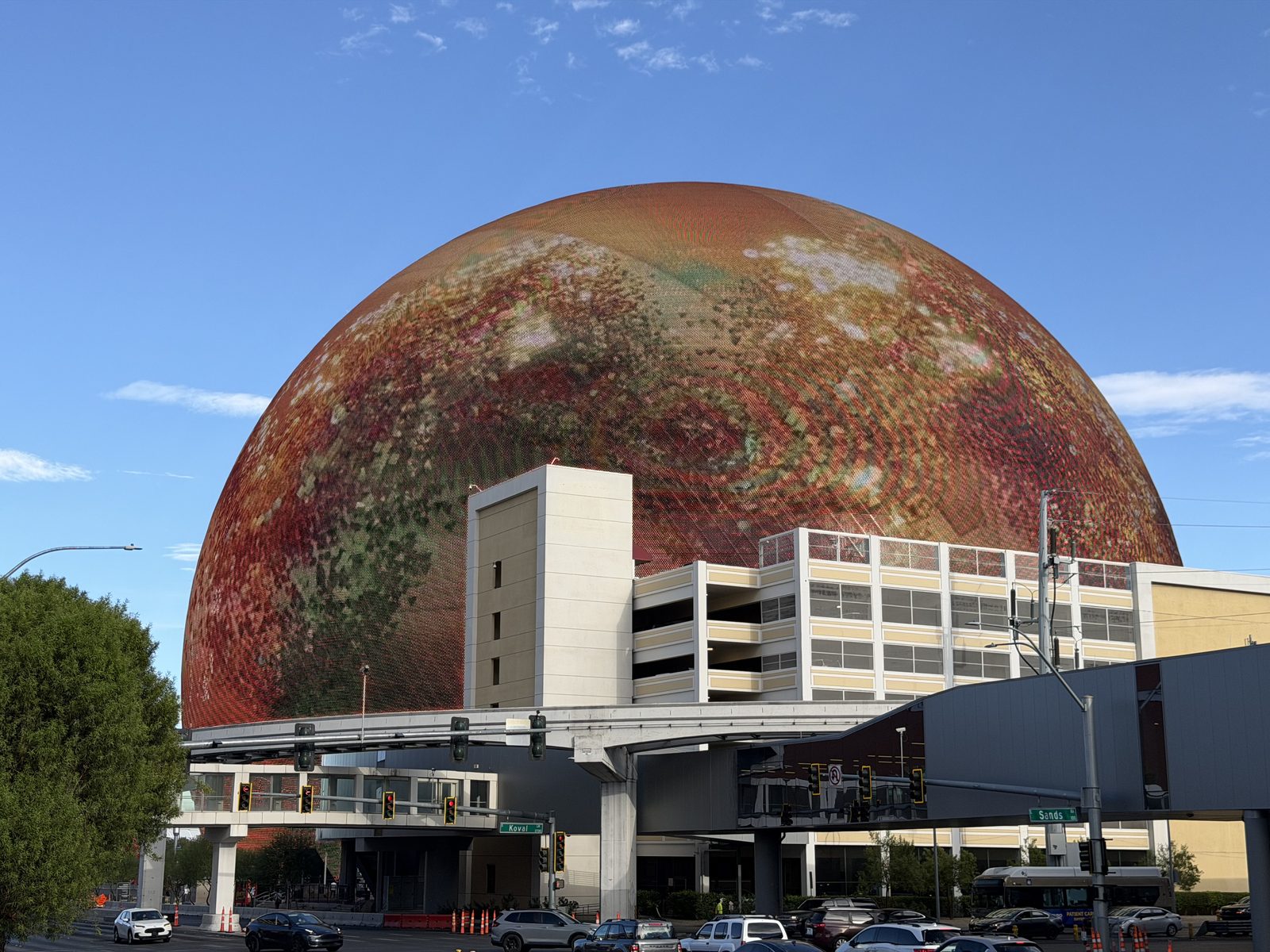 The Sphere in Las Vegas by day showing a planet rendered across its full exterior display