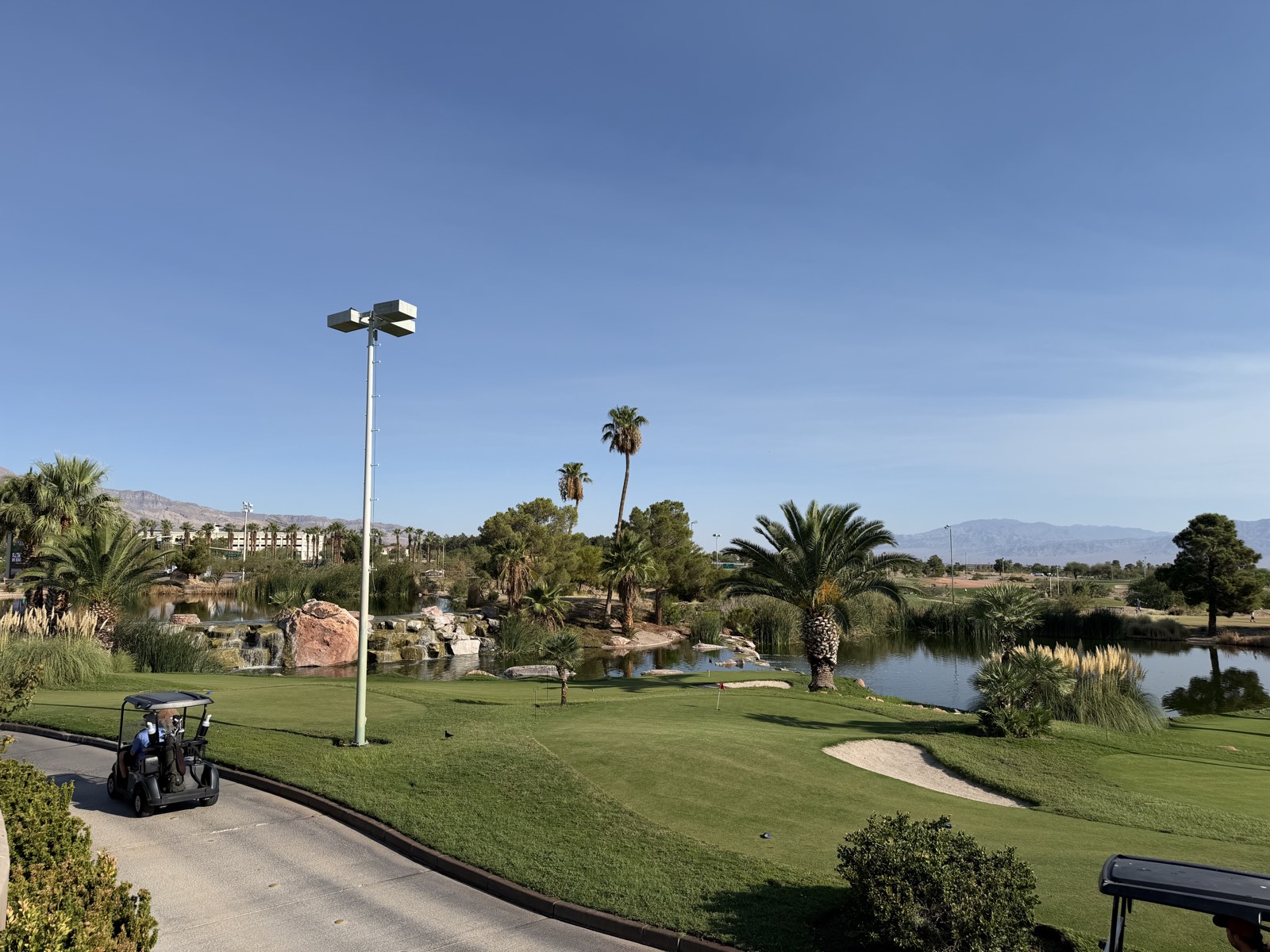 A green fairway lined with palm trees against the desert mountains in Summerlin, Las Vegas