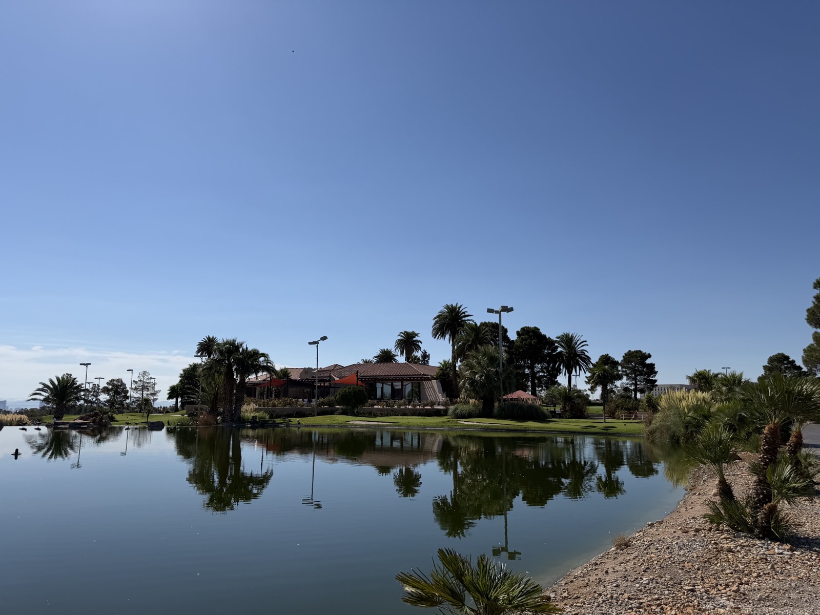 A water feature and manicured fairway with desert mountains behind, Summerlin, Las Vegas